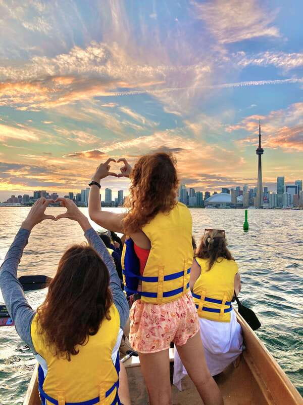 Toronto Islands: Sunset Canoe Tour - Climbing into the Voyageur-style canoe